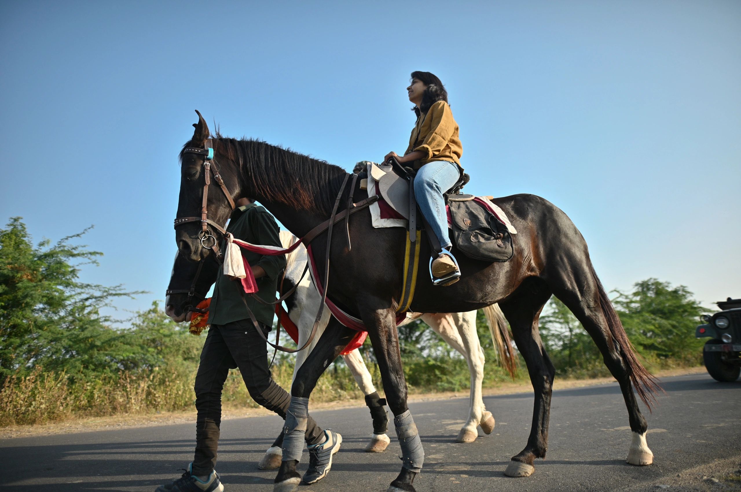 Woman and daughter enjoying horseback riding in nature