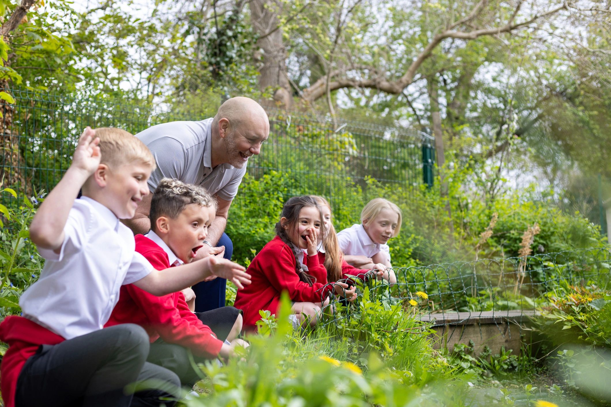 Children learning together outdoors in a group setting