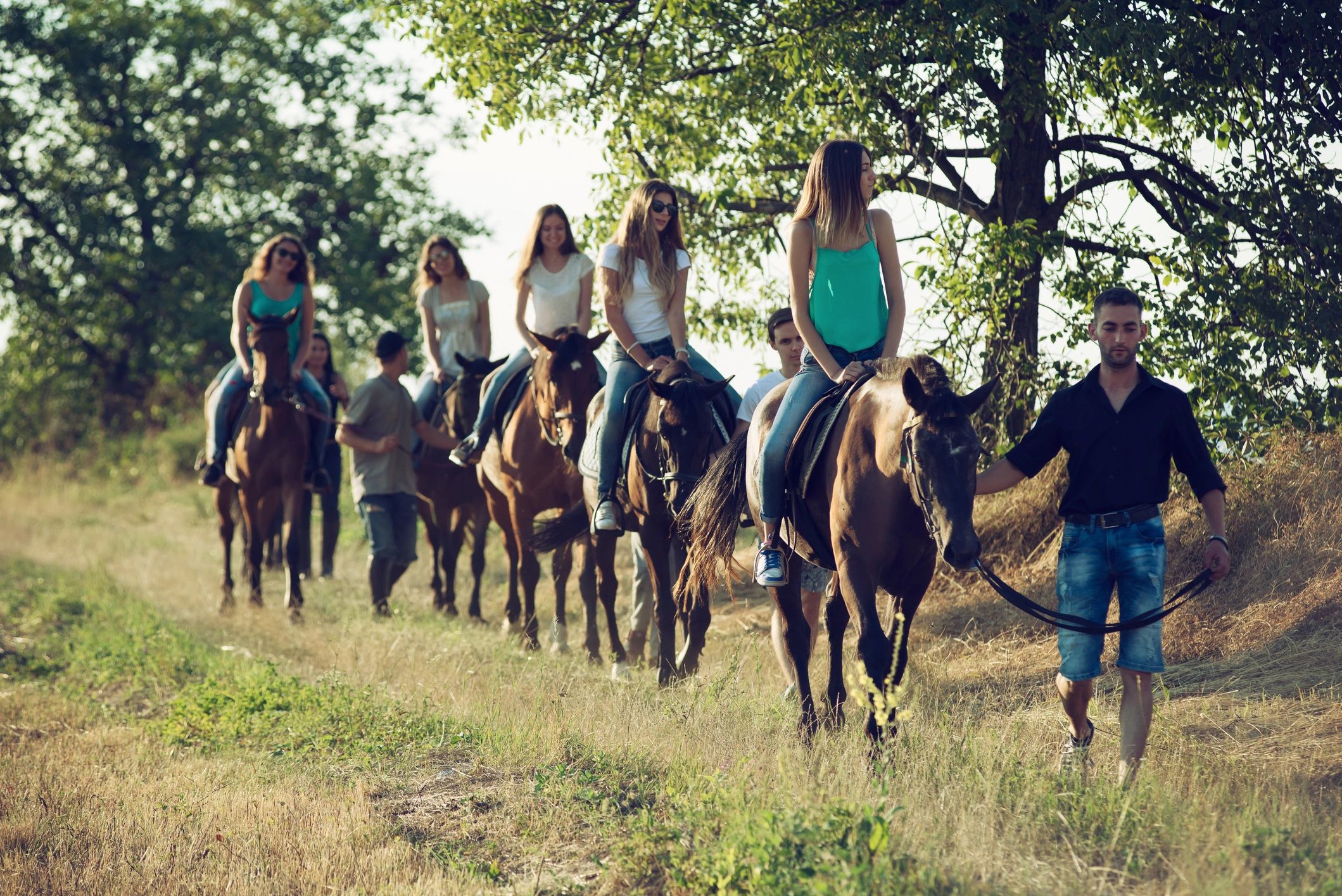 Group horseback ride through the countryside
